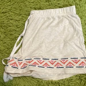 beige pajama shorts with design on bottom